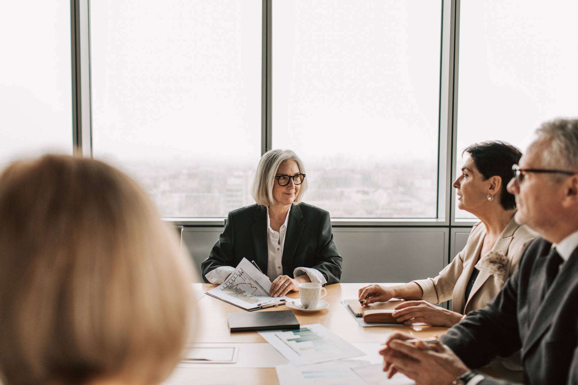 Corporate legal consultation in a modern glass boardroom