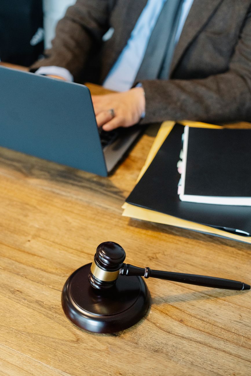 Judges gavel on corporate mahogany desk in office library
